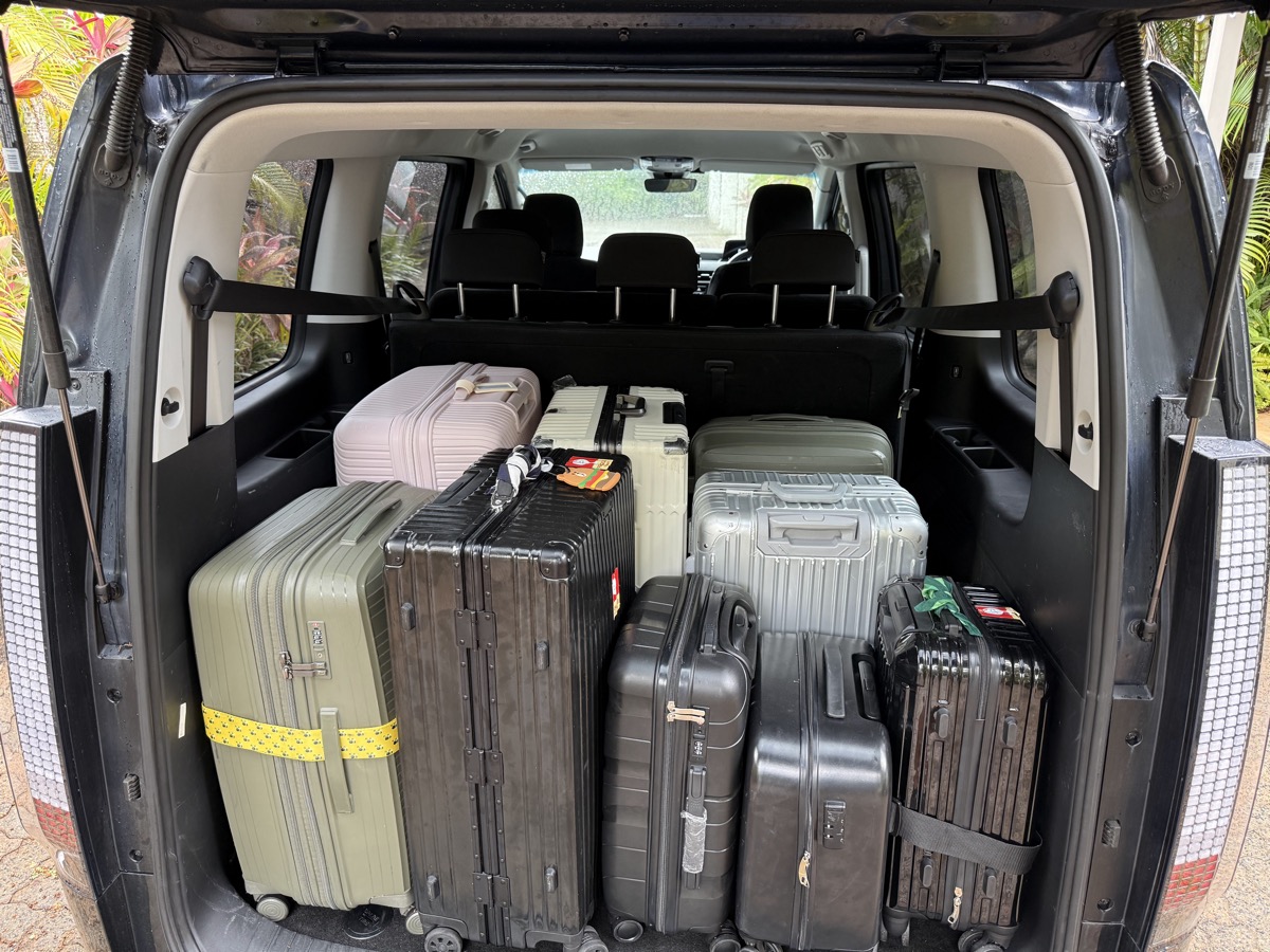 Suitcases loaded in the boot of a private transfer van